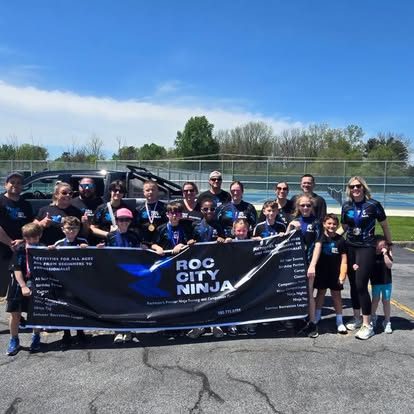 ROC City Ninja athletes and families with the team banner